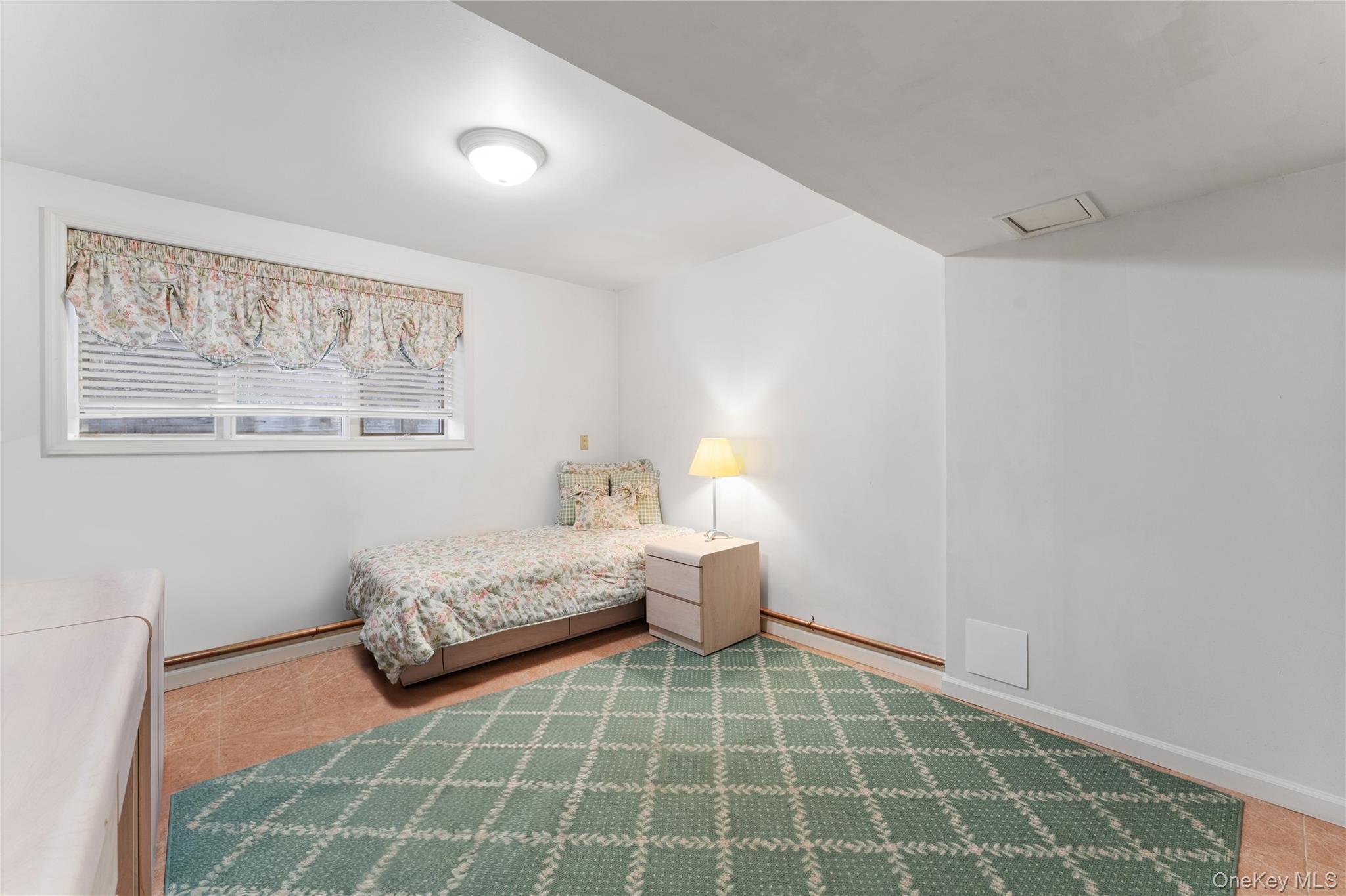 24 Olmsted Road Scarsdale, NY 10583 - Photo 28 of 39 a spacious bathroom with a double vanity sink and a mirror