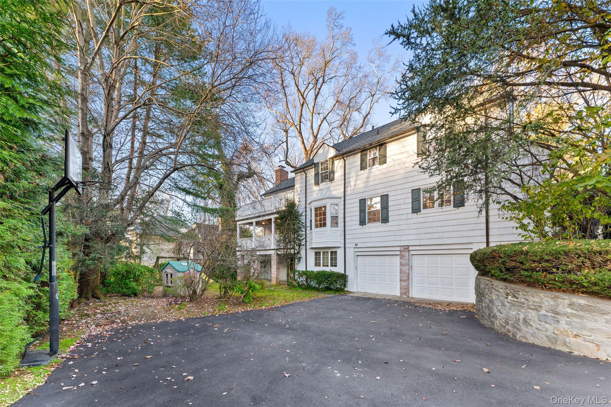 24 Olmsted Road Scarsdale, NY 10583 - Photo 30 of 39 a front view of a house with a yard and garage