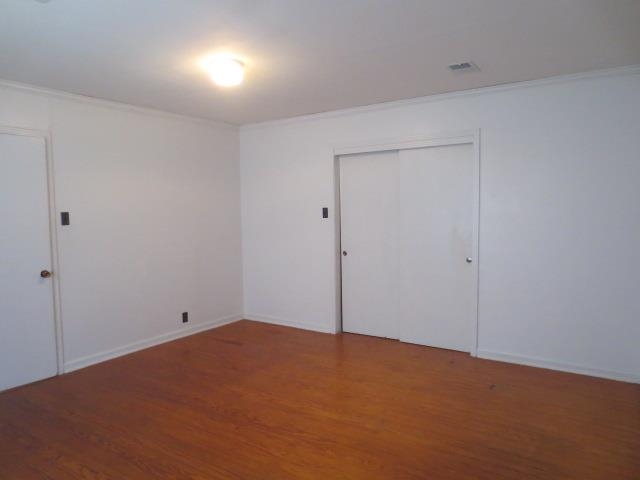 6386 Highway 209 Ripley, TN 38063 - Photo 11 of 23 Unfurnished bedroom with wood finished floors, a closet, and crown molding