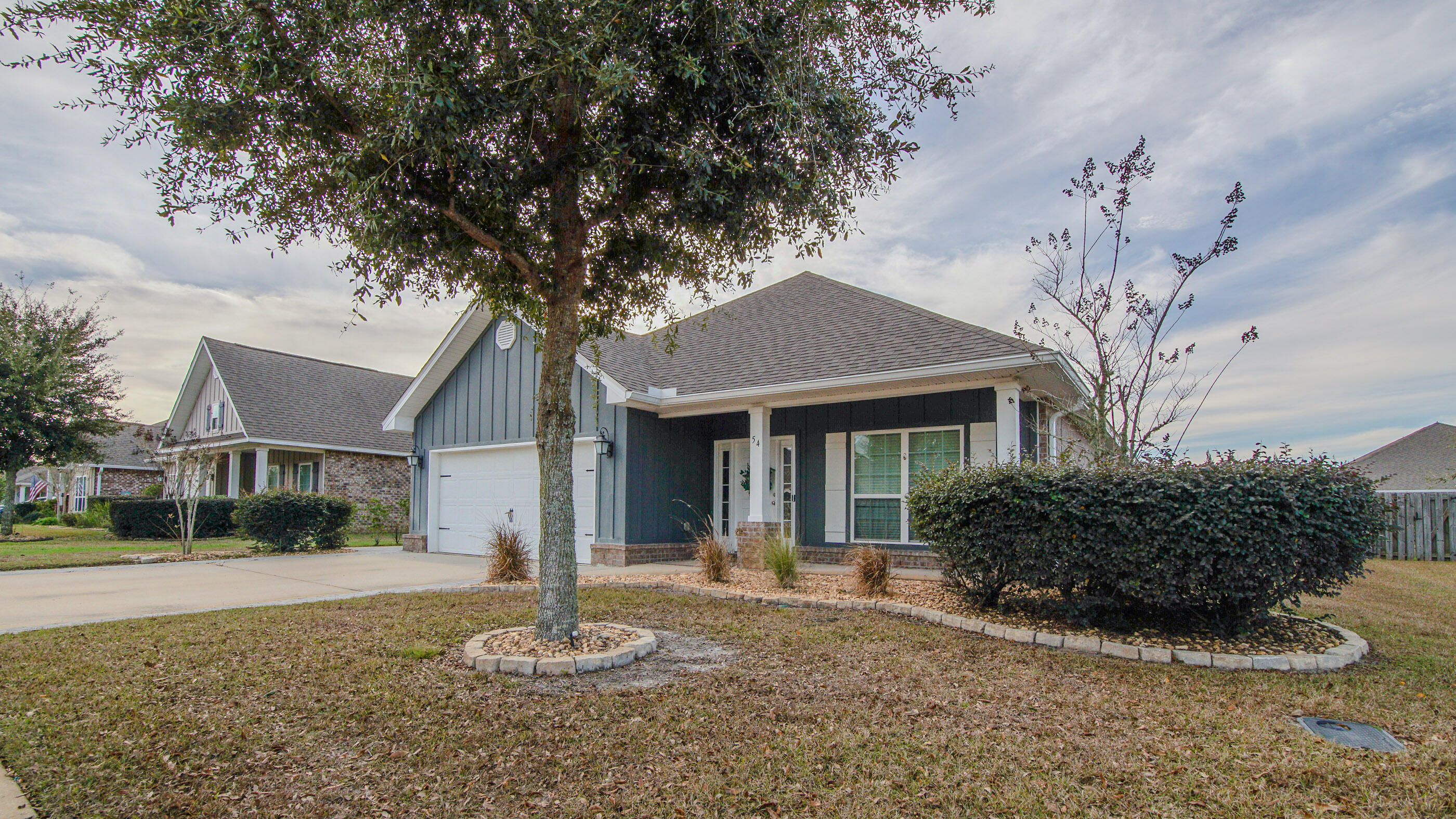 54 Lottie Loop Freeport, FL 32439 - Photo 7 of 63 a front view of a house with a yard and garage