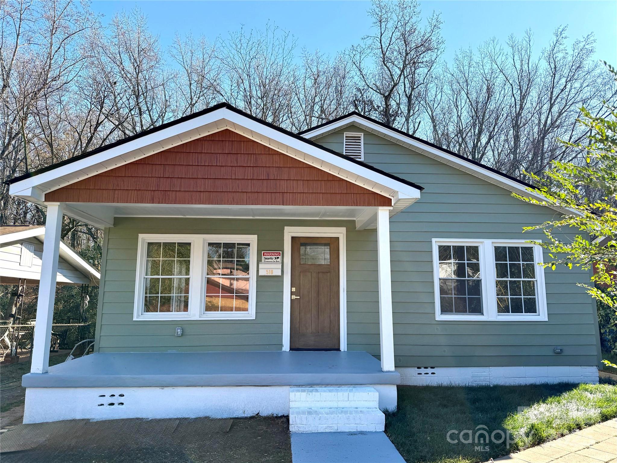 a front view of a house with yard and green space