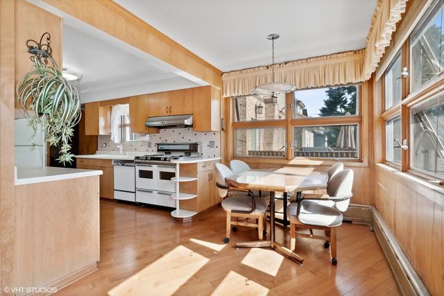 a dining room with furniture and a kitchen view