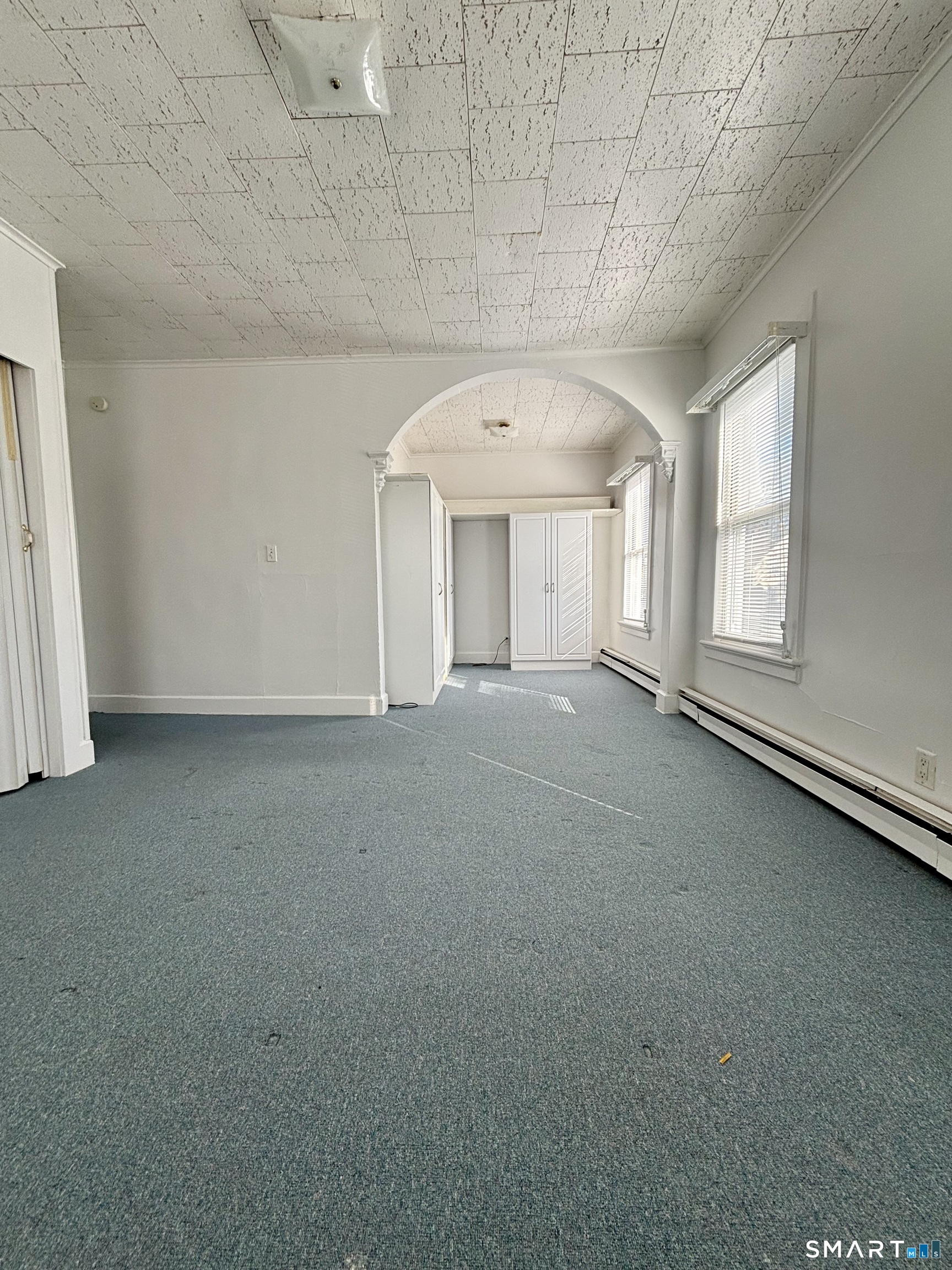 73 Peck Street, Unit 2 Norwich, CT 06360 - Photo 5 of 10 an empty room with windows