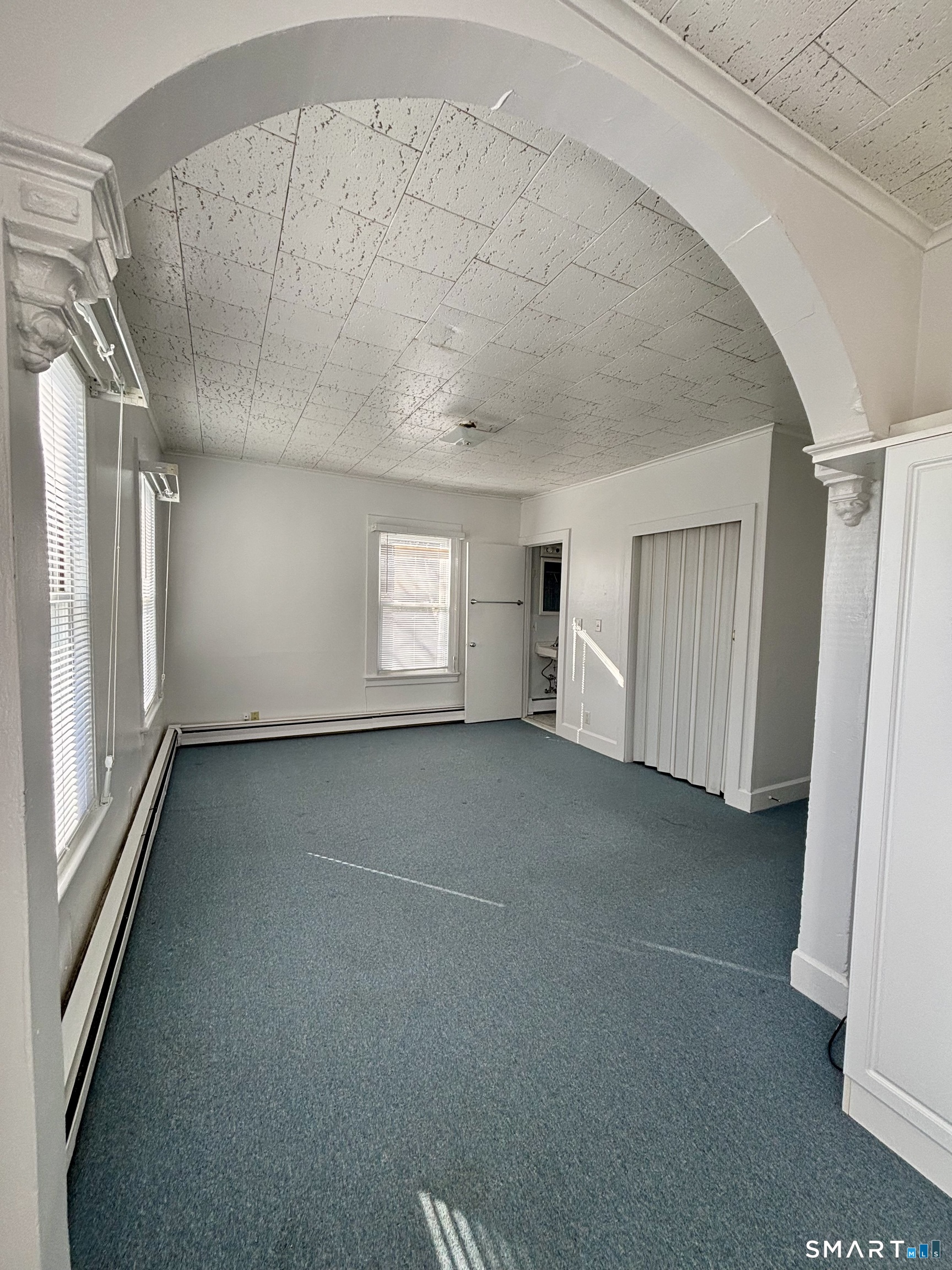 73 Peck Street, Unit 2 Norwich, CT 06360 - Photo 6 of 10 a view of empty room with windows
