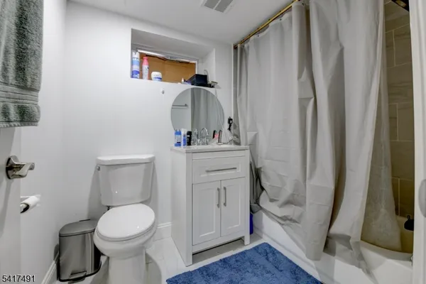 a view of a yard in front of a house with large tree