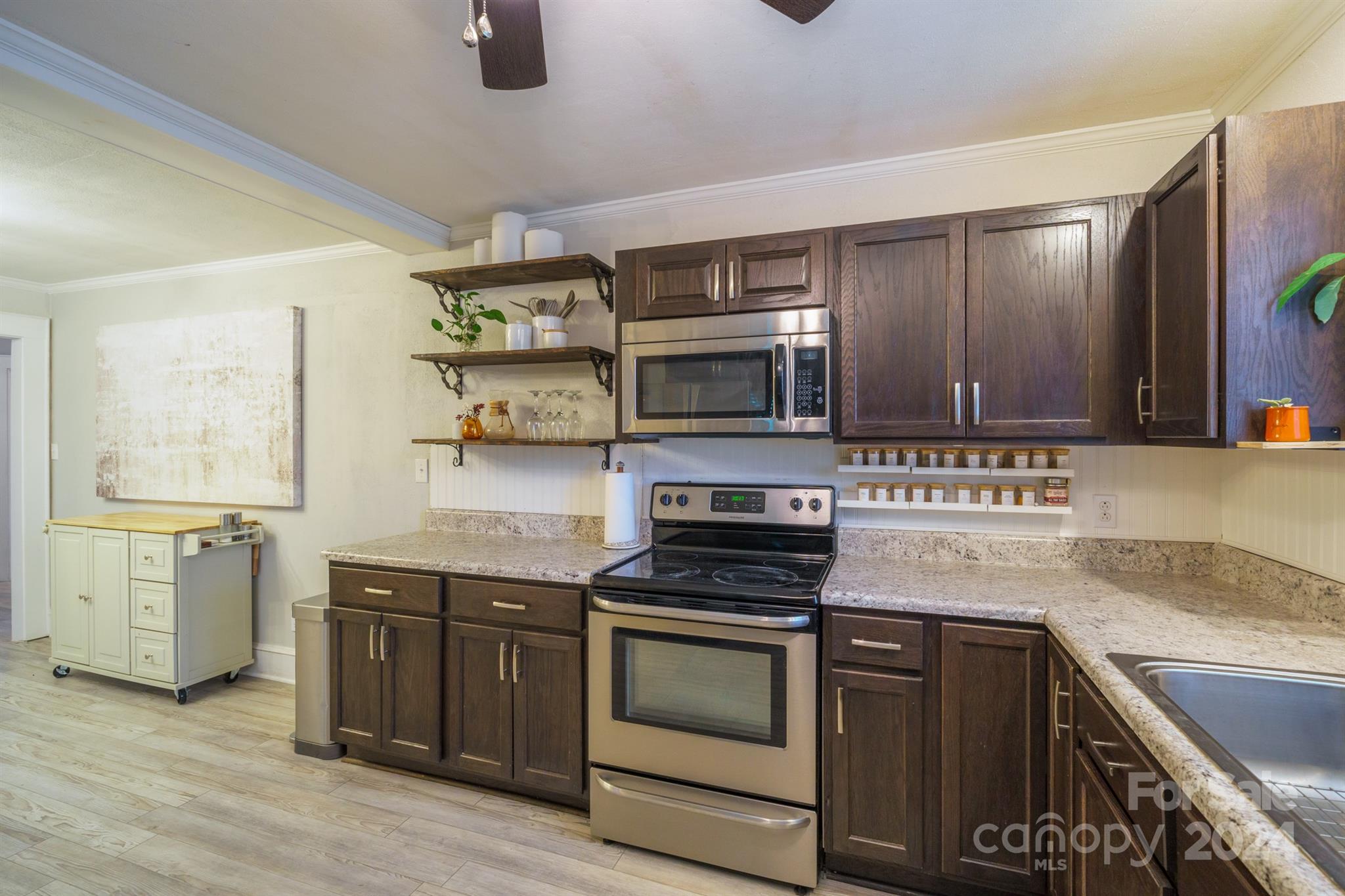 1072 5th Street Northeast Hickory, NC 28601 - Photo 13 of 27 a kitchen with stainless steel appliances granite countertop a stove and a sink