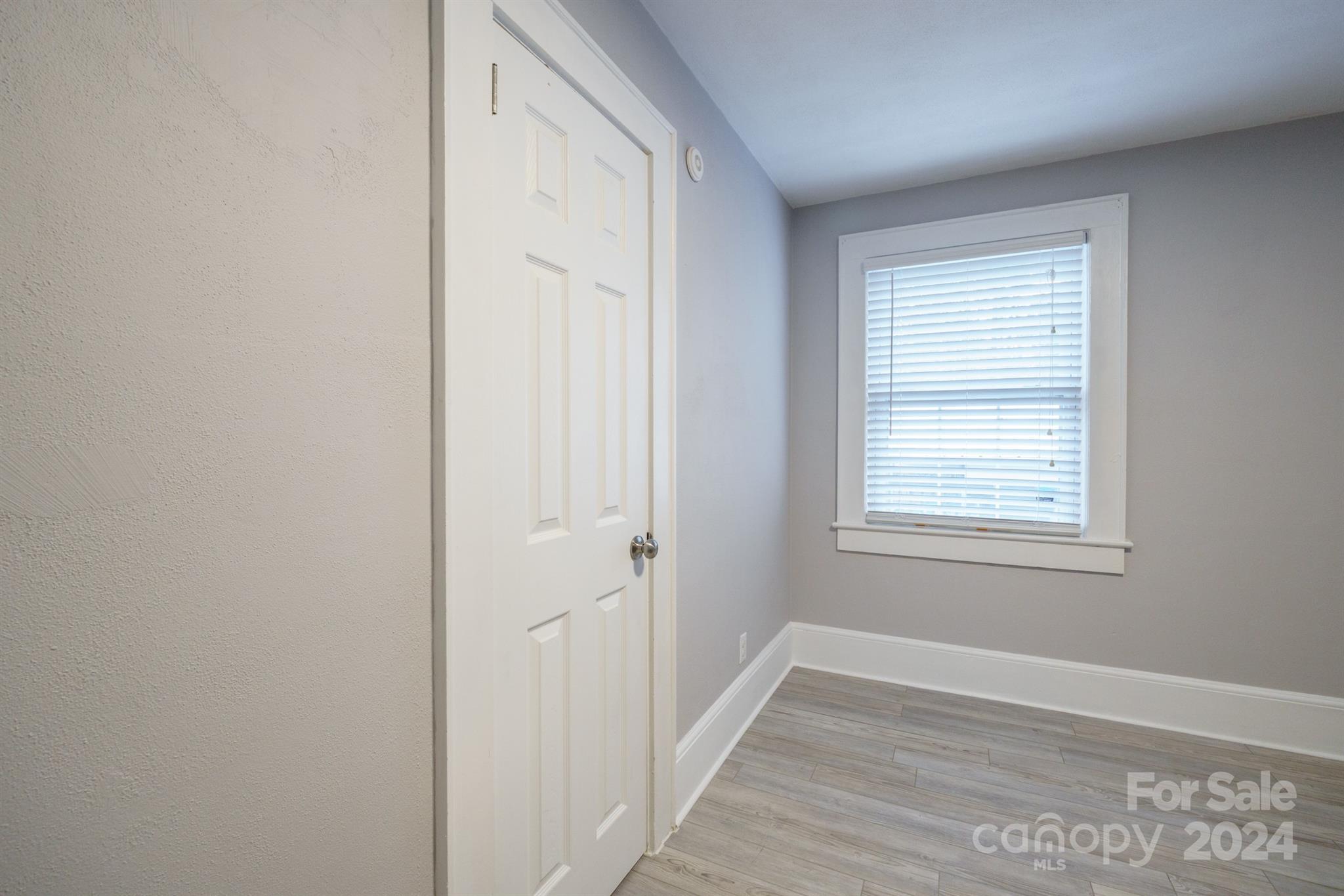 1072 5th Street Northeast Hickory, NC 28601 - Photo 24 of 27 a view of an empty room with wooden floor and a window