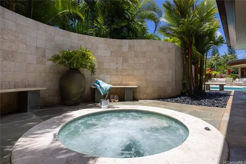 a view of a swimming pool with a bench in patio