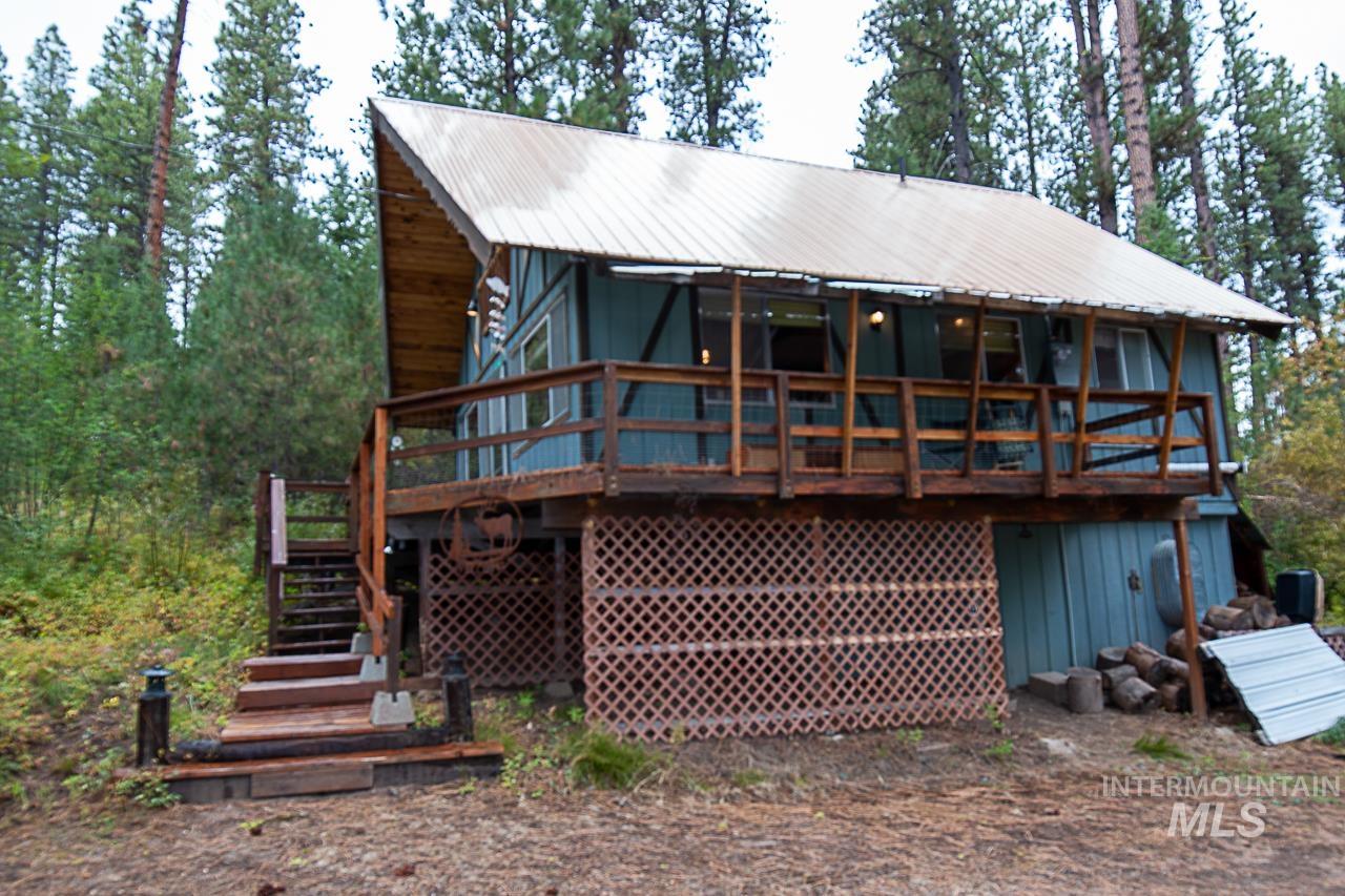 225 Mesplie Road Placerville, ID 83666 - Photo 28 of 39 Back of house featuring a wooden deck, a metal roof, and stairway
