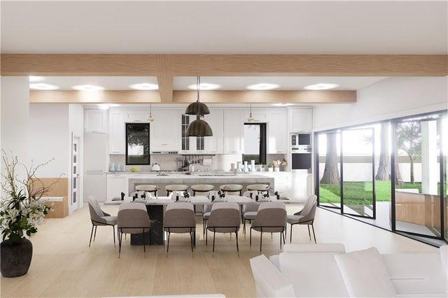 a large kitchen with a table and chairs