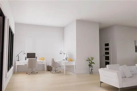 a living room with furniture and white wall painting