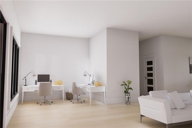 a living room with furniture and white wall painting