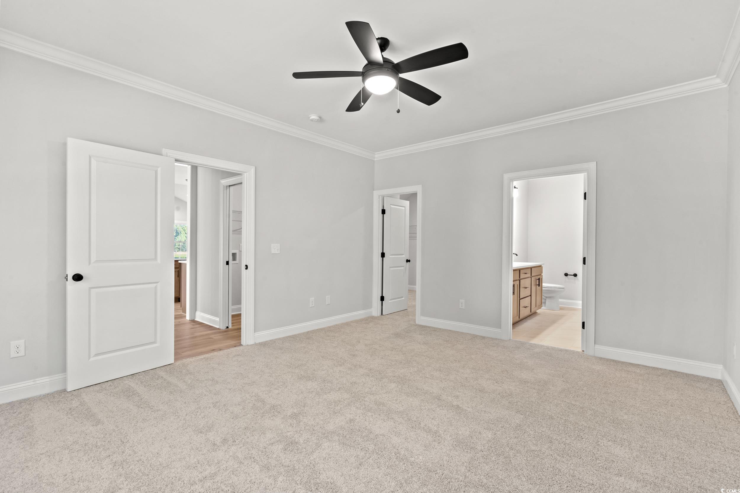 1201 Crooked Hook Road North Myrtle Beach, SC 29582 - Photo 18 of 23 Empty room featuring ornamental molding, light carpet, and ceiling fan
