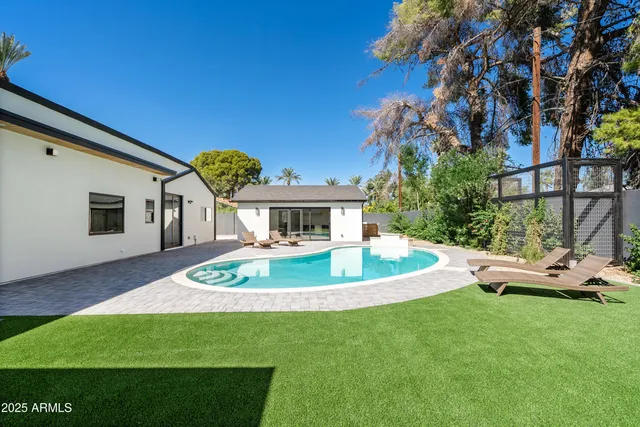 a front view of a house with a garden