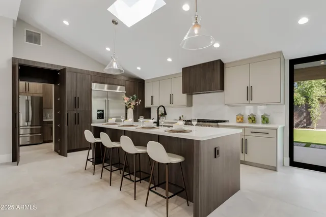 a kitchen that has a lot of cabinets in it and appliances