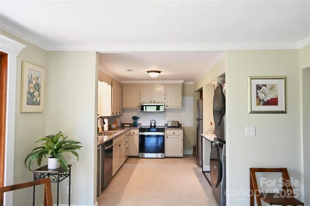 a kitchen with stainless steel appliances a refrigerator and a stove top oven