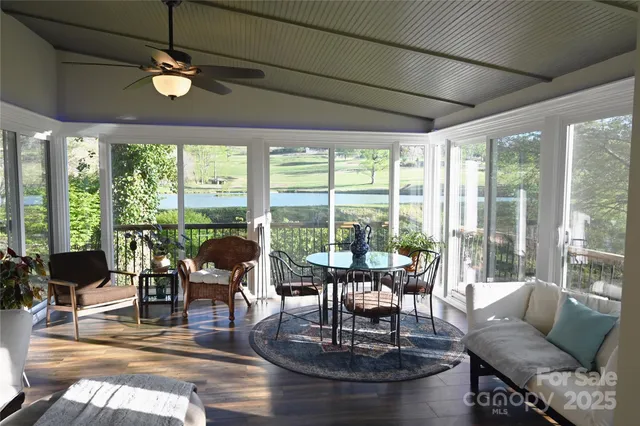 a living room with furniture and floor to ceiling windows