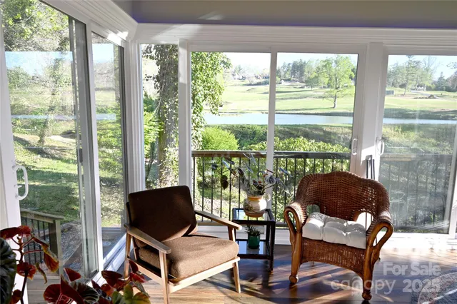 a living room with furniture and floor to ceiling windows