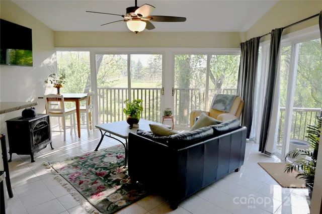 a living room with a large window and a table