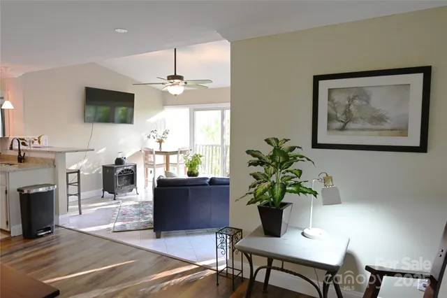 a dining room with furniture potted plants and a fireplace