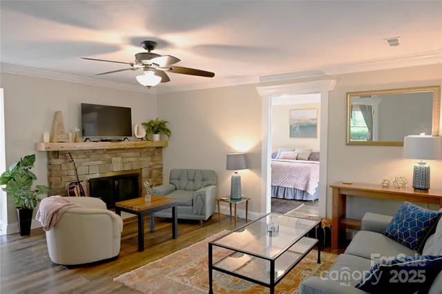 a living room with furniture a fireplace and a flat screen tv