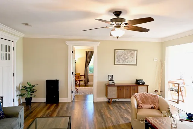 a living room with furniture and wooden floor