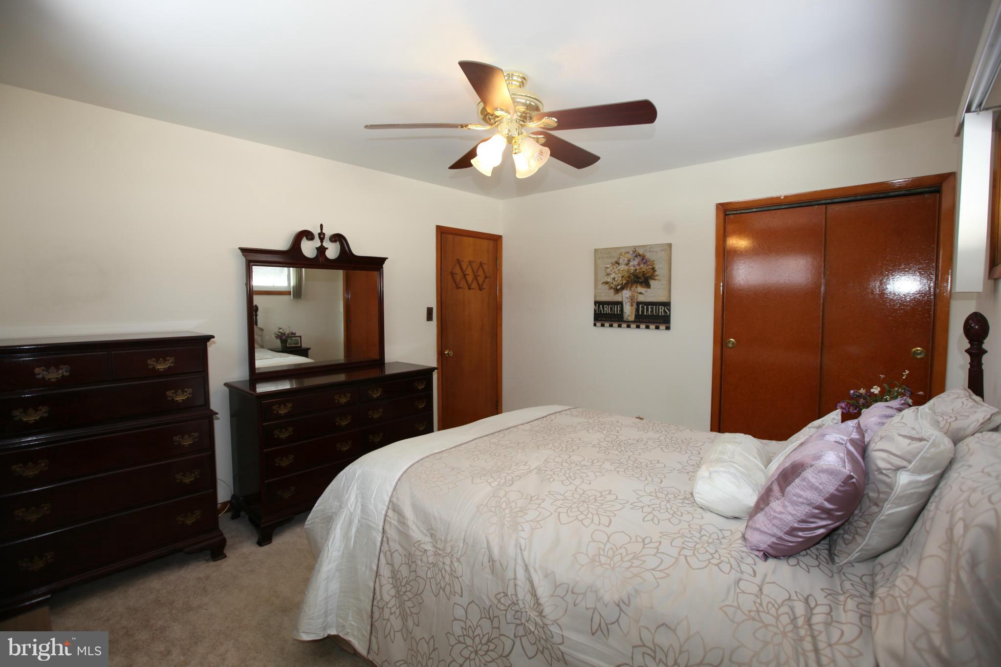 1808 Willann Road Baltimore, MD 21237 - Photo 13 of 23 a bedroom with a bed and a chandelier