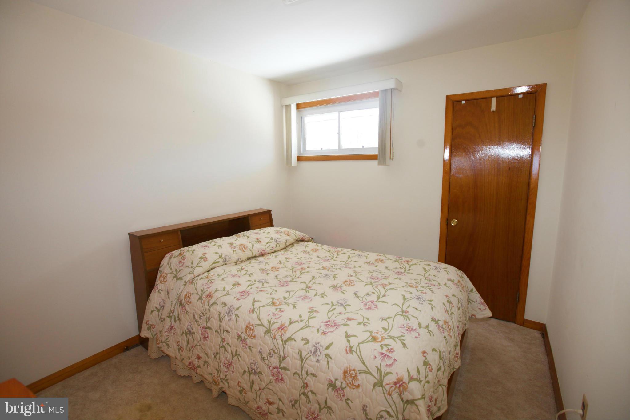 1808 Willann Road Baltimore, MD 21237 - Photo 15 of 23 a bedroom with a bed and wooden floor