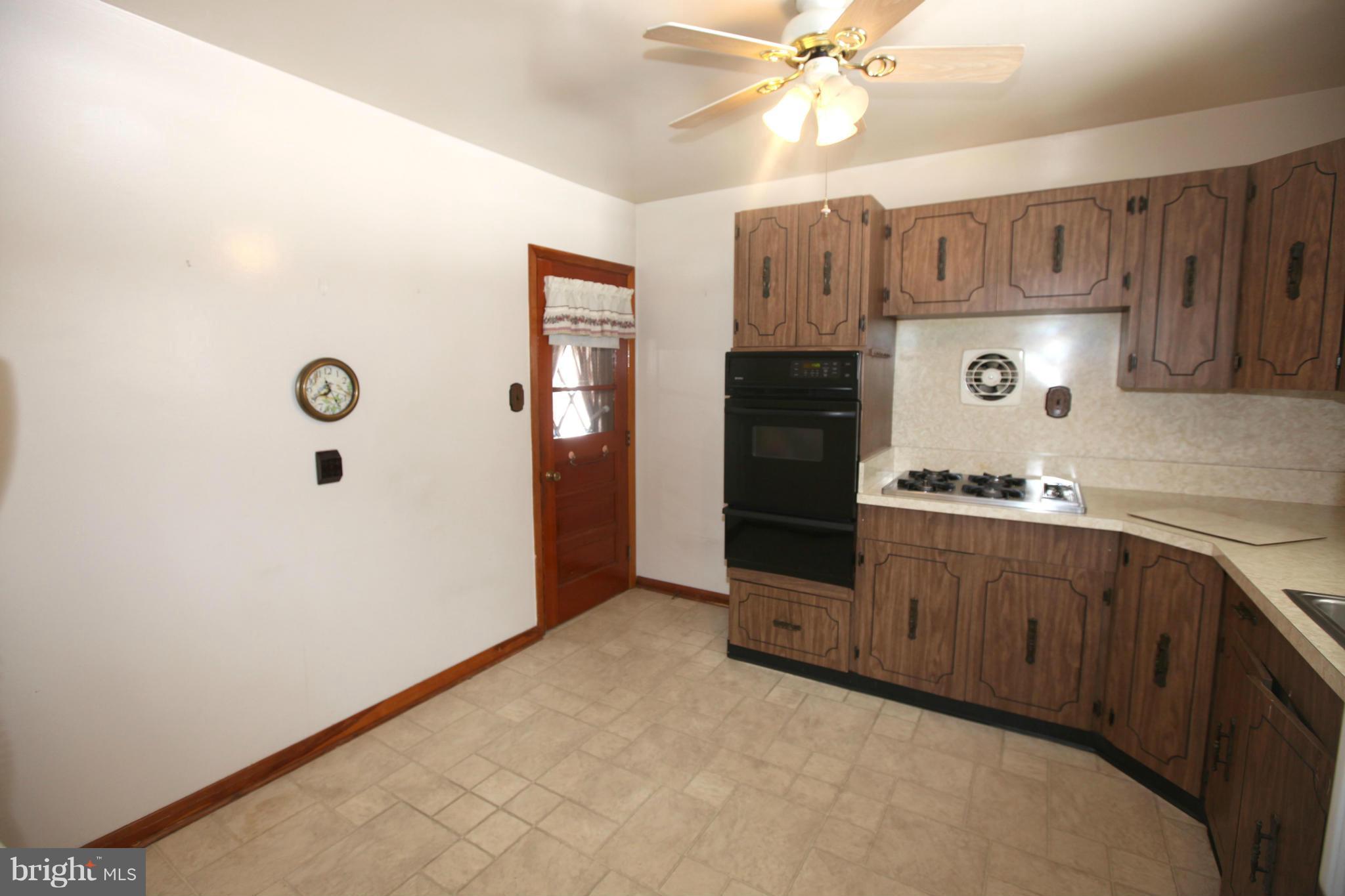 1808 Willann Road Baltimore, MD 21237 - Photo 8 of 23 a kitchen with stainless steel appliances granite countertop a refrigerator a stove and a sink