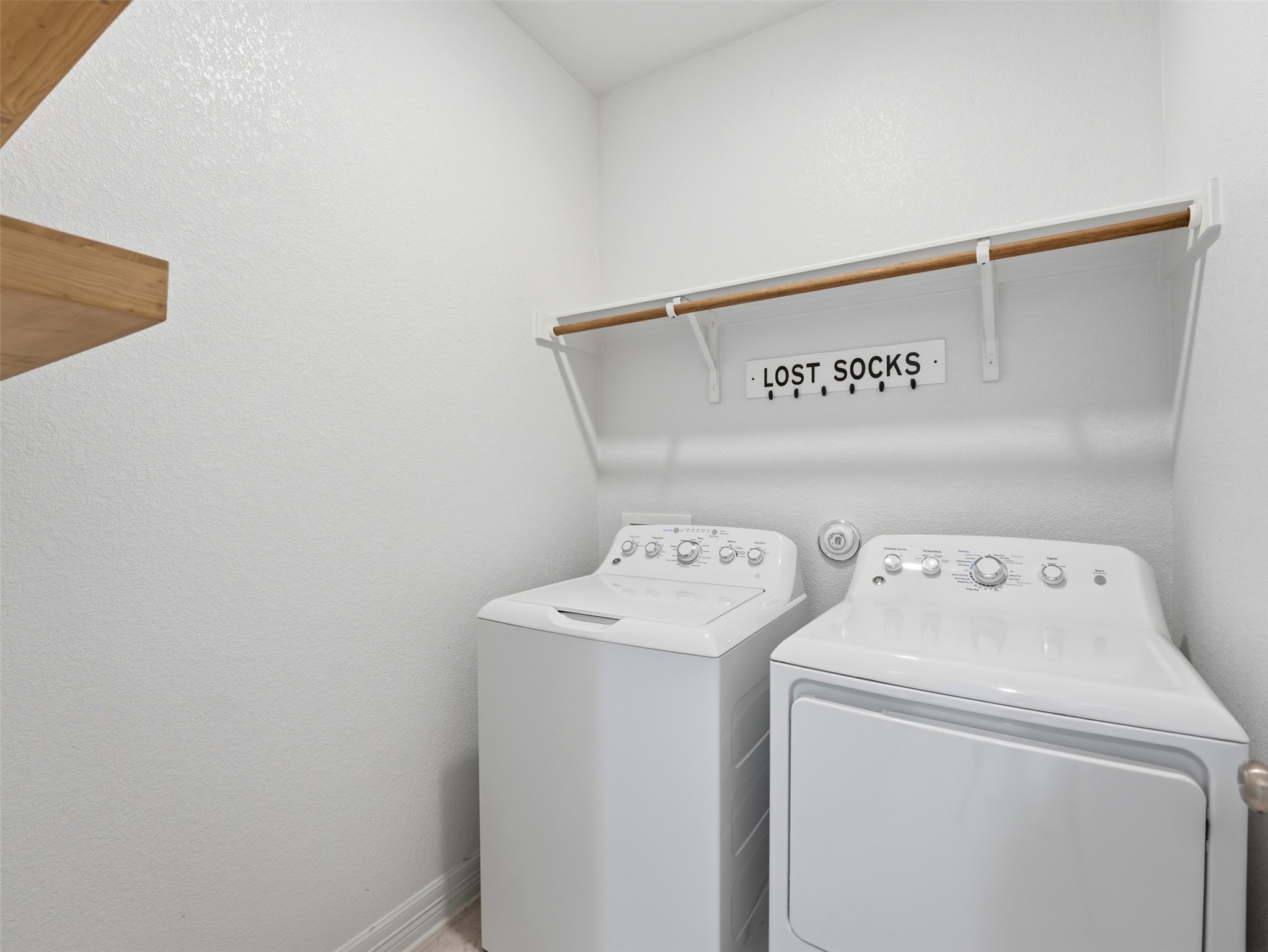 2132 Ringstaff Road Leander, TX 78641 - Photo 39 of 39 Functional laundry space featuring modern appliances and a convenient hanging rod for garments.