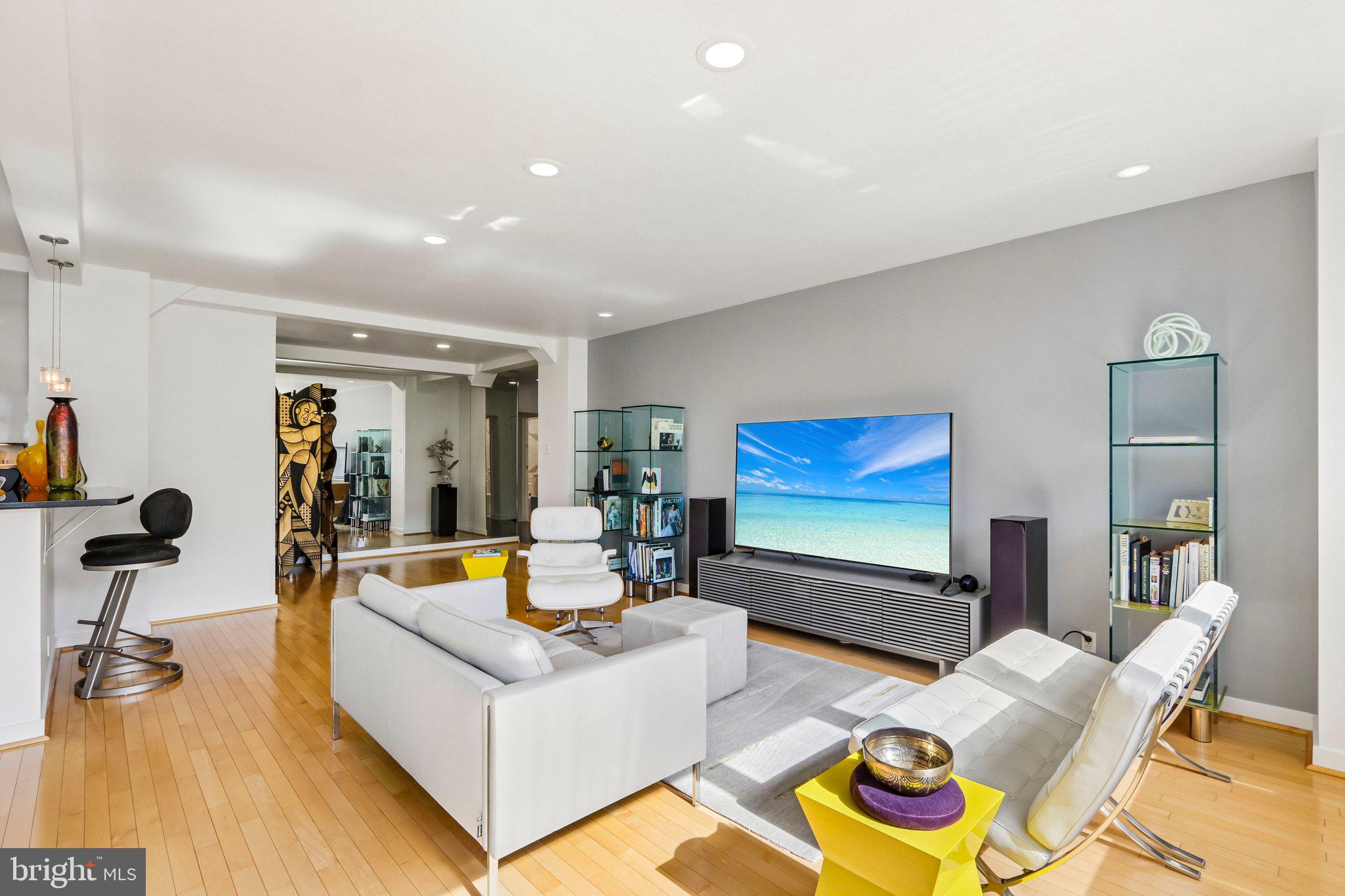 220 West Rittenhouse Square, Unit 10C Philadelphia, PA 19103 - Photo 13 of 39 a living room with furniture and a flat screen tv with wooden floor