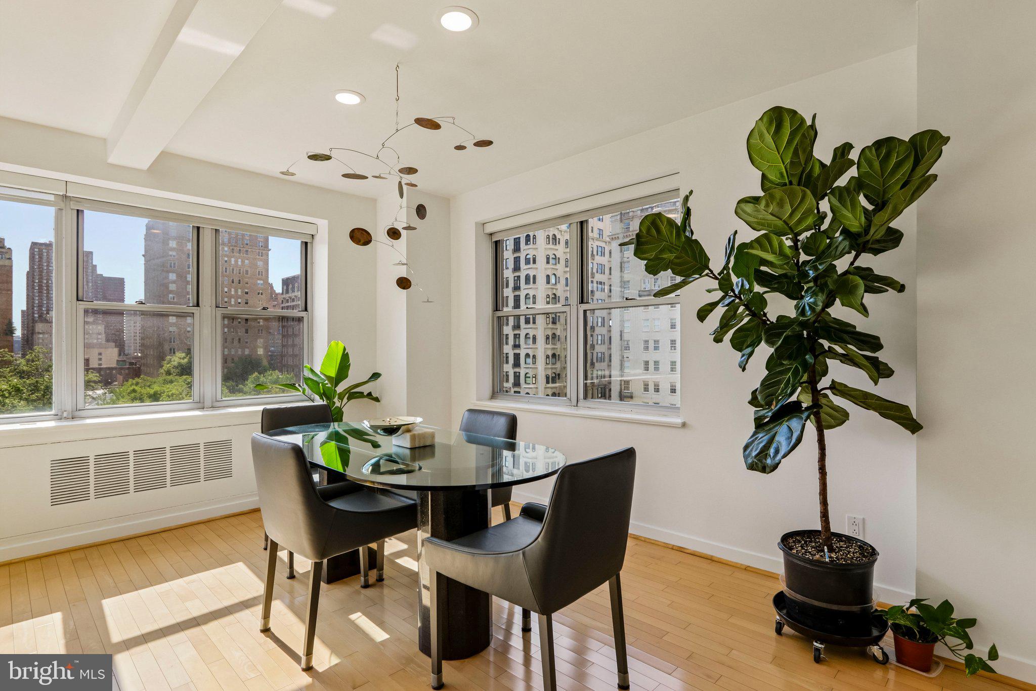 220 West Rittenhouse Square, Unit 10C Philadelphia, PA 19103 - Photo 15 of 39 a dining room with furniture potted plants and wooden floor