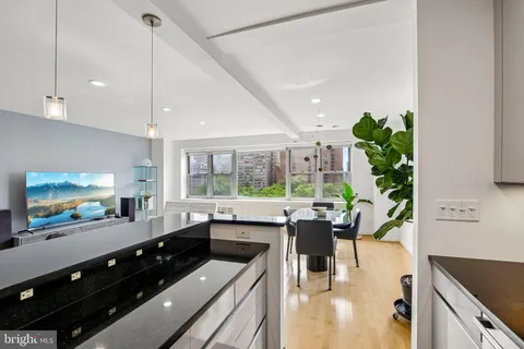 a kitchen view of a stove and a wooden floors