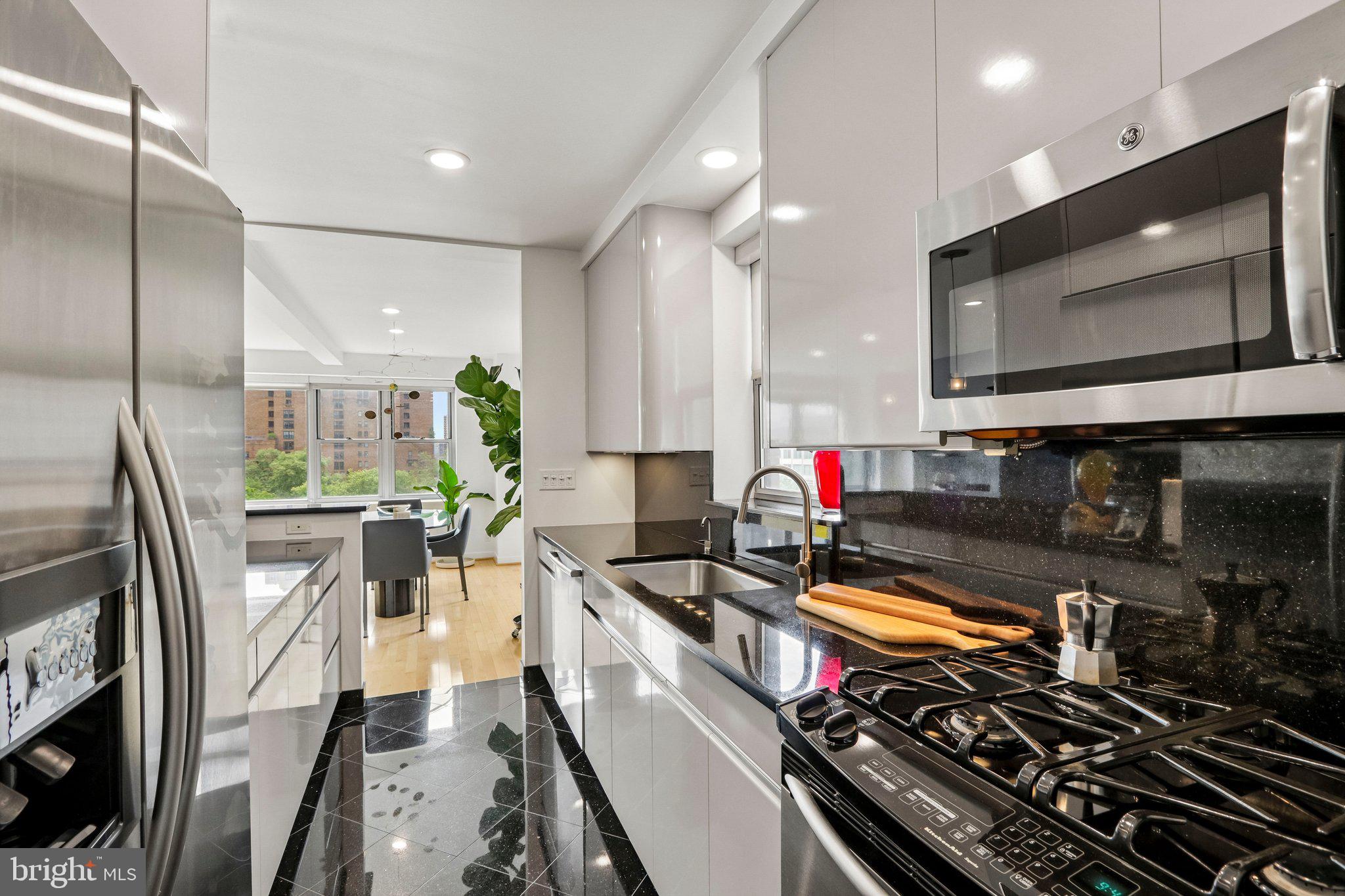 220 West Rittenhouse Square, Unit 10C Philadelphia, PA 19103 - Photo 20 of 39 a kitchen with stainless steel appliances a stove a sink and a microwave