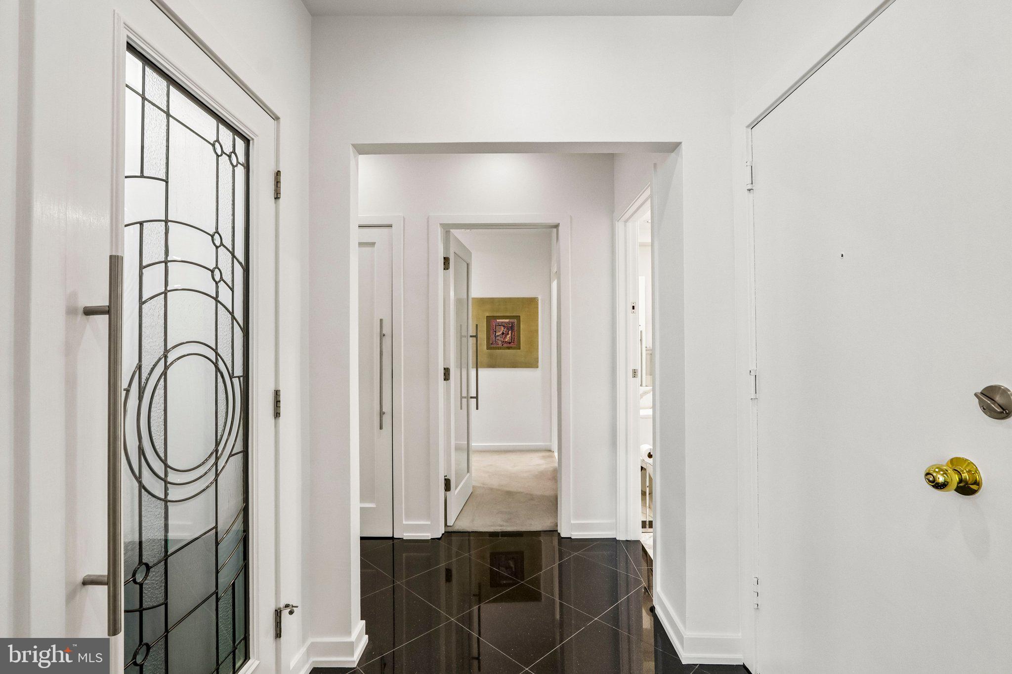 220 West Rittenhouse Square, Unit 10C Philadelphia, PA 19103 - Photo 21 of 39 a view of a hallway with wooden cabinets