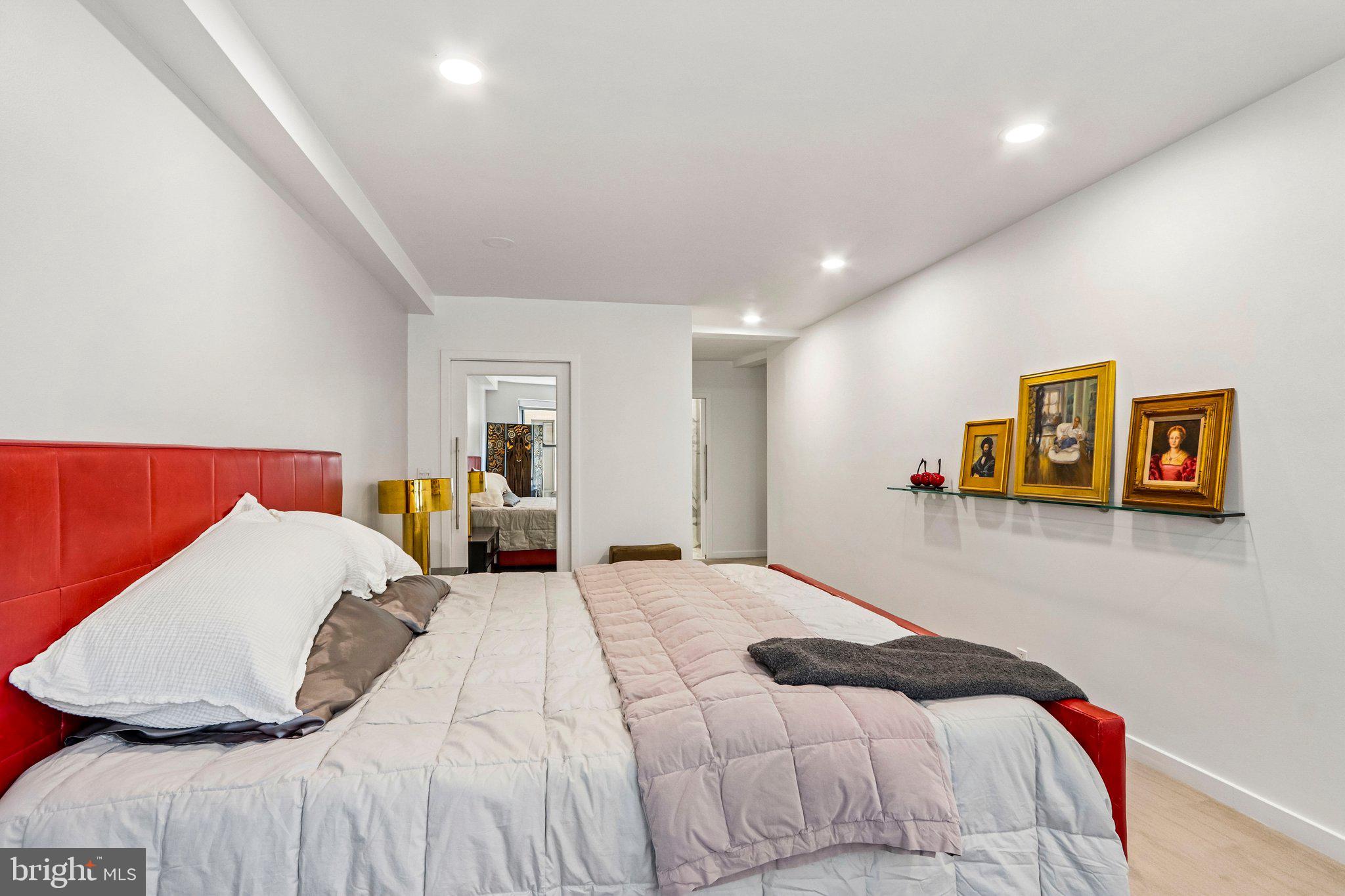 220 West Rittenhouse Square, Unit 10C Philadelphia, PA 19103 - Photo 23 of 39 a bedroom with a large bed and a couch
