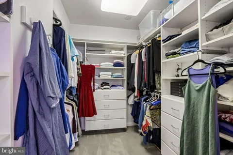 a bathroom with double vanity sinks a toilet a mirror and shower