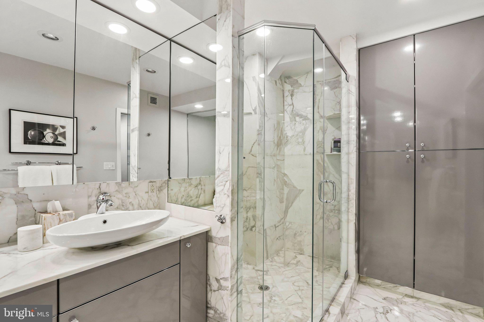 220 West Rittenhouse Square, Unit 10C Philadelphia, PA 19103 - Photo 27 of 39 a bathroom with a sink and a mirror