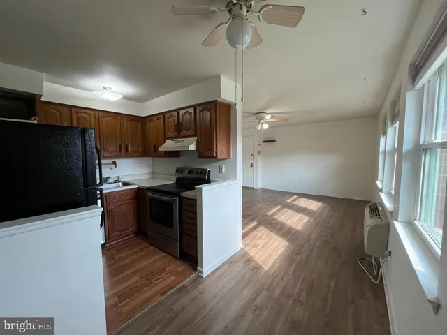 a kitchen with stainless steel appliances granite countertop a sink a stove a microwave and cabinets