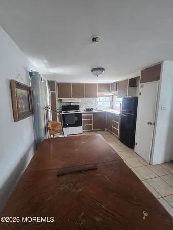 a kitchen with a stove a microwave and a window