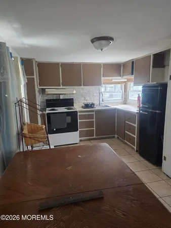 a view of a livingroom with a sink and cabinets