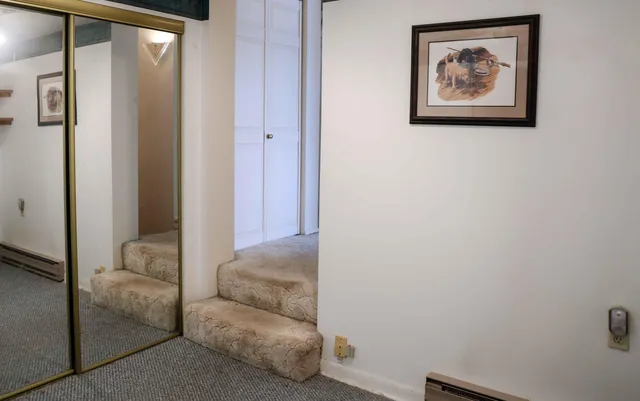 a bedroom with a bed and hallway