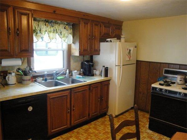 27 Campechi Street Springfield, MA 01104 - Photo 3 of 17 a kitchen with a sink a refrigerator and a stove