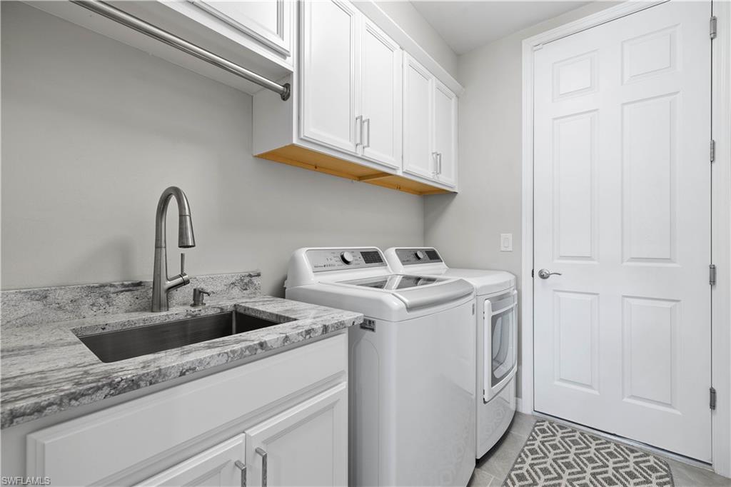 14558 Edgewater Circle Naples, FL 34114 - Photo 21 of 40 a utility room with sink dryer and washer
