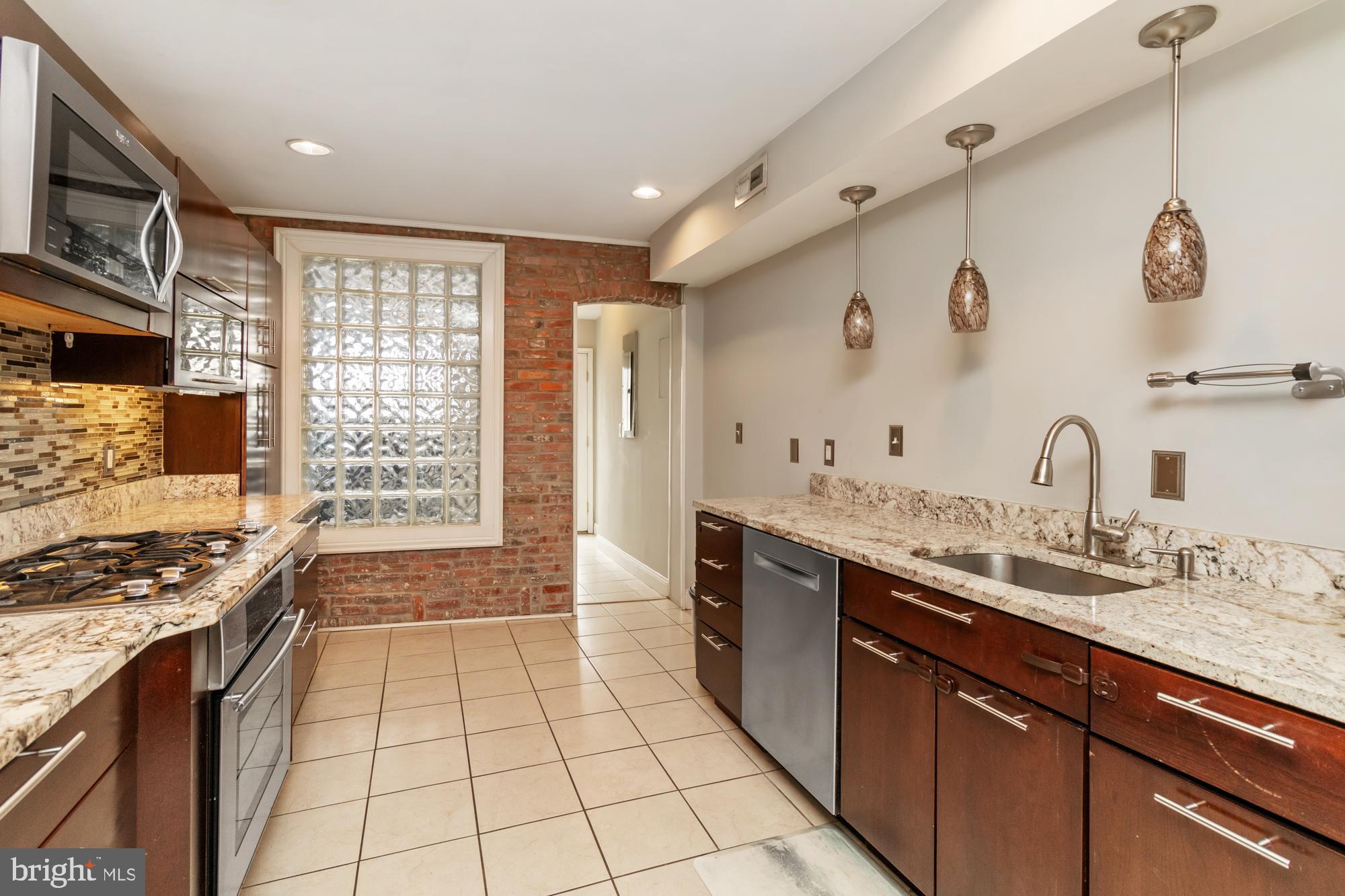 1812 Light Street Baltimore, MD 21230 - Photo 11 of 45 a spacious bathroom with a granite countertop sink a mirror and shower