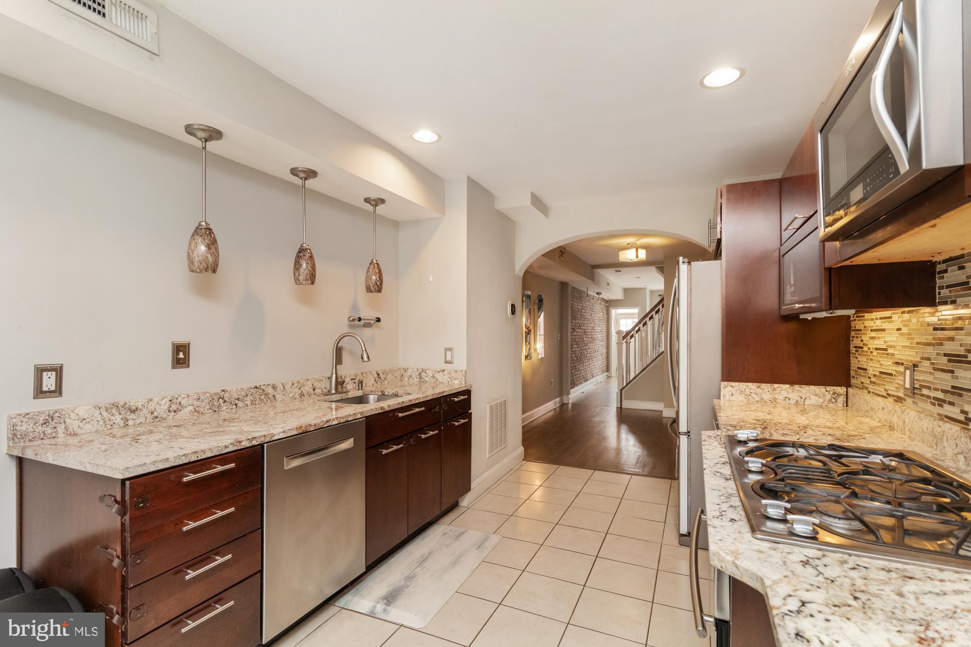 1812 Light Street Baltimore, MD 21230 - Photo 12 of 45 a kitchen with stainless steel appliances granite countertop a sink stove and cabinets