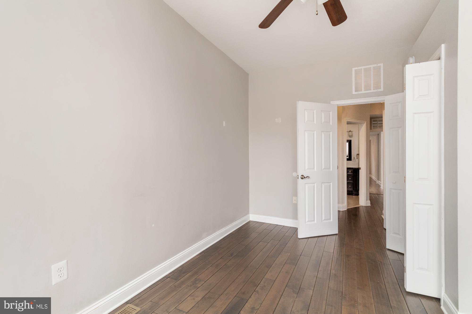 1812 Light Street Baltimore, MD 21230 - Photo 18 of 45 an empty room with closet and wooden floor