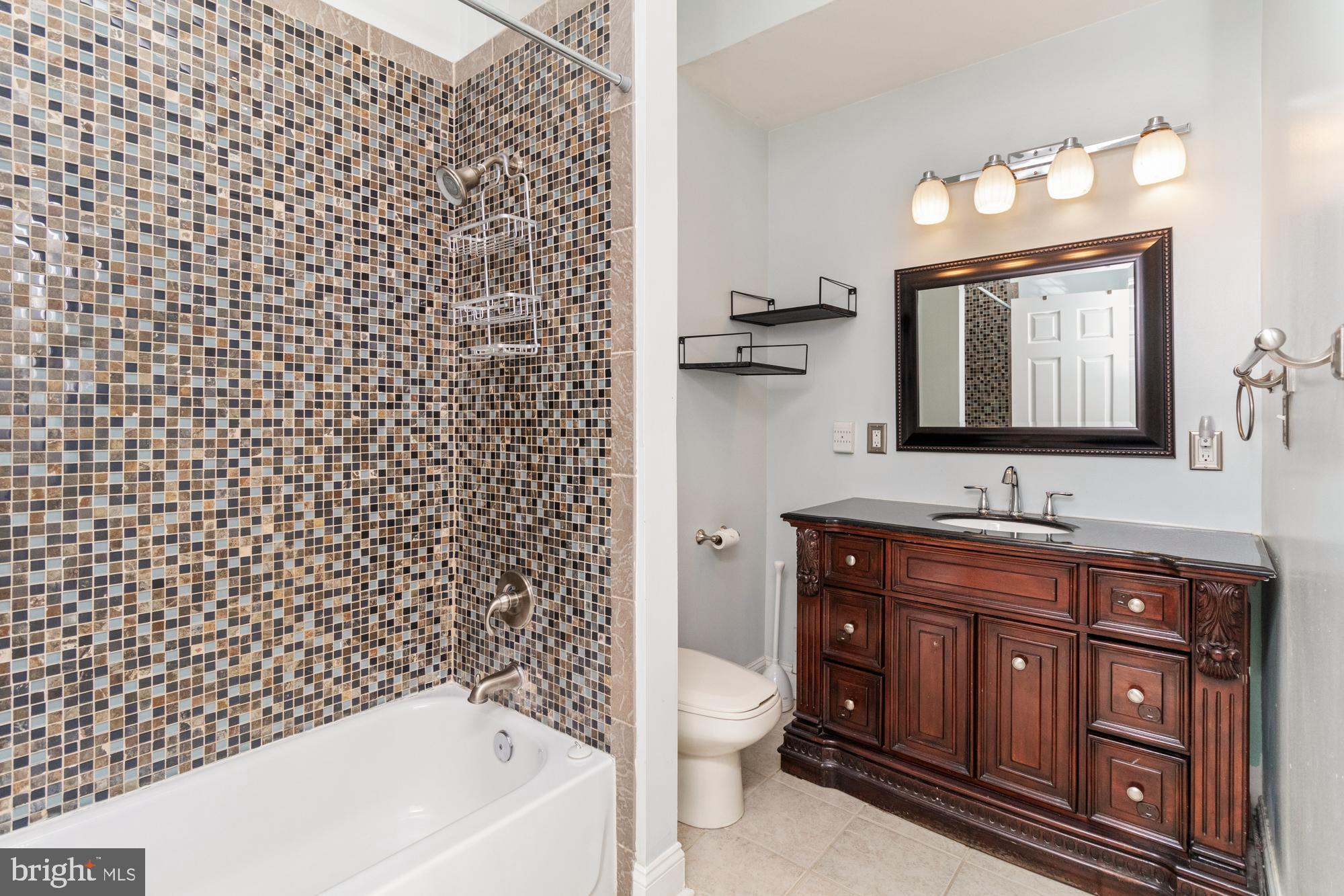 1812 Light Street Baltimore, MD 21230 - Photo 21 of 45 a bathroom with a bathtub sink vanity mirror and toilet