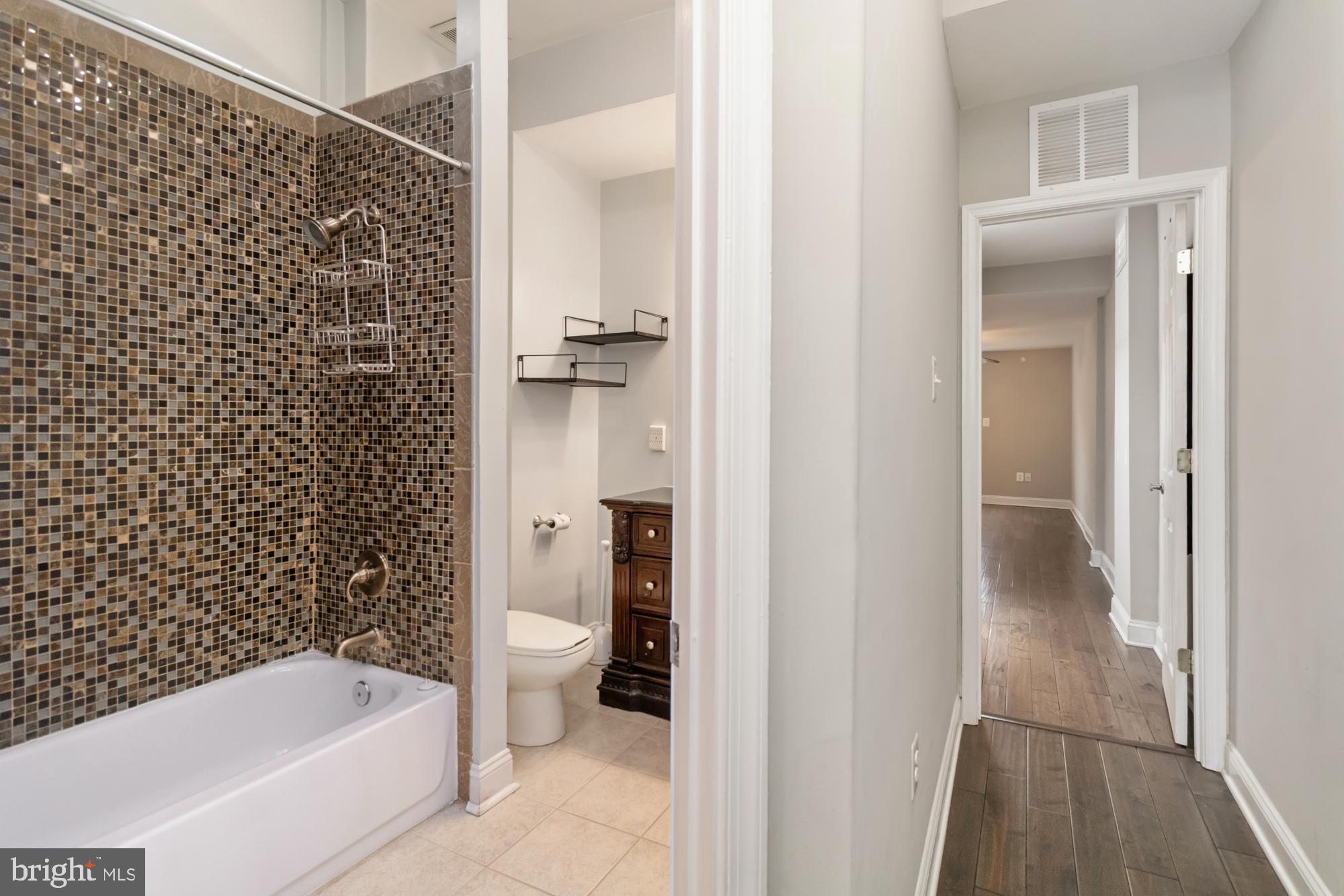 1812 Light Street Baltimore, MD 21230 - Photo 22 of 45 a bathroom with a bathtub and a toilet