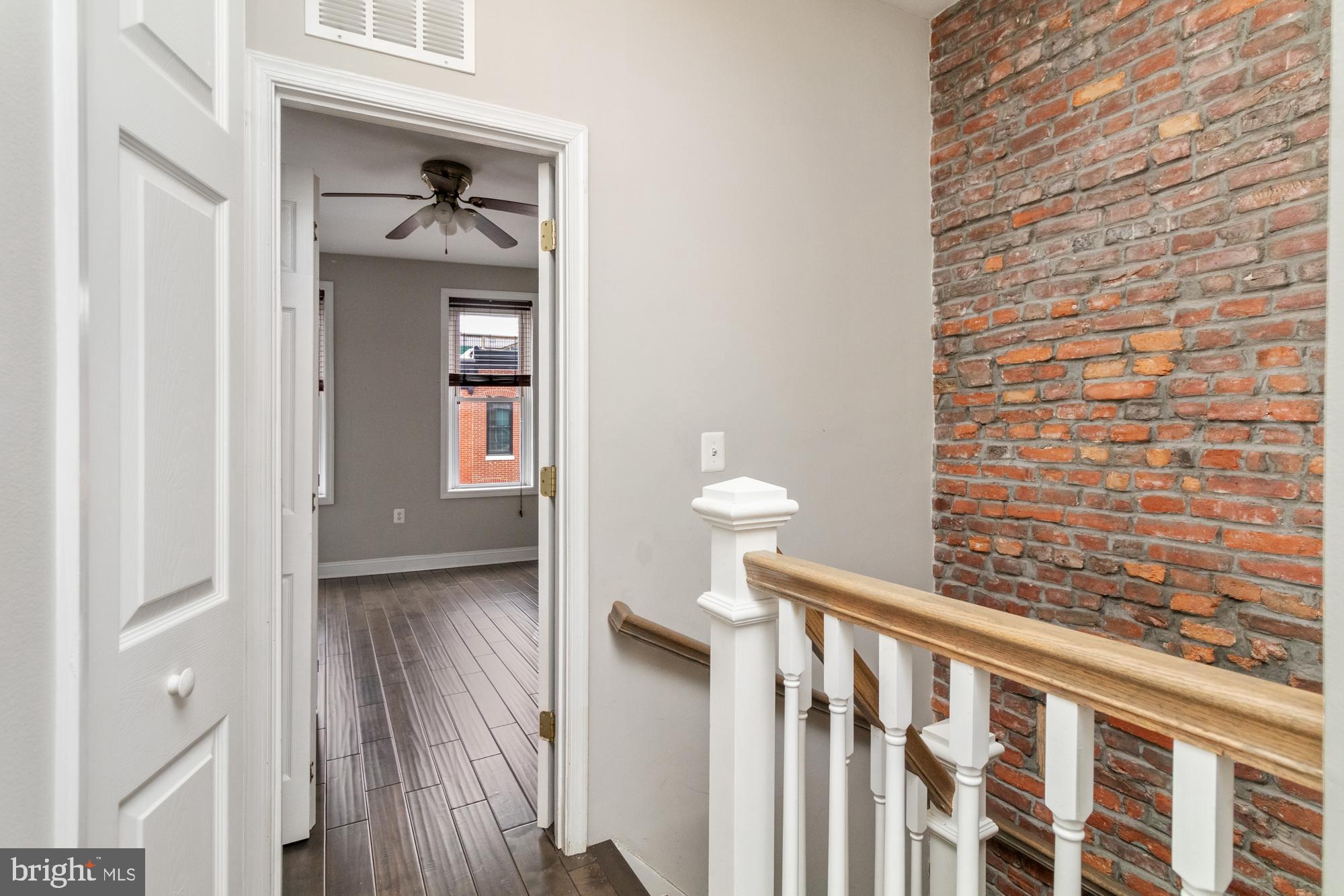 1812 Light Street Baltimore, MD 21230 - Photo 23 of 45 a view of a hallway with wooden floor and a bathroom